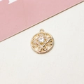Macro view of a gold-plated flower pendant with a white zircon and hollow heart patterns - No.03