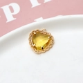 Golden lace heart pendant with a faceted yellow crystal and textured woven border - Yellow