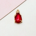 Detail of red teardrop pendant with gold floral edge and crystal-like texture - 8*17MM / Red