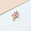 Macro shot of gold-plated five-petal flower pendant with pink cubic zirconia stones - Pink