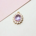 Detail of oval lavender crystal pendant with white zircon halo and golden setting - 14*19mm / Light Purple