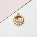 Macro detail of oval champagne zircon pendant with gold-plated setting for jewelry making - 14*19mm / Champagne