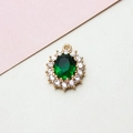 Macro view of emerald green oval pendant with white zircon halo and gold plating - 14*19mm / Green
