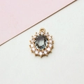 Macro shot of oval dark grey zircon pendant with white crystal halo on gold setting - 14*19mm / Light Gray