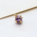 Macro shot of cubic gold-plated pendant with sparkling purple zircon gemstones - Small / Violet
