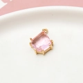 Macro shot of geometric pink crystal pendant with gold plating for DIY jewelry making - Pink