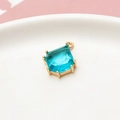 Macro detail of sky blue teardrop crystal pendant with gold claw setting for DIY jewelry - Lake Blue