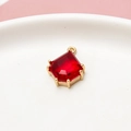 Macro shot of a red geometric teardrop pendant with gold plated copper edging - Dark Red