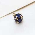 Detailed macro view of a navy blue faceted gemstone in a geometric gold metal frame charm - Large / Dark Blue