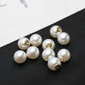 Macro detail of high-luster white pearl earring backs with golden metal bases on black background - 10mm / K Gold