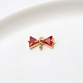 Macro shot of gold-plated bow charm with red zircon stones and dual hanging loops - Red Double Hanging Bowknot (LF2239)