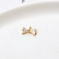 Macro shot of gold bow pendant featuring triangle-cut cubic zirconia and top hanging ring - White Single Hanging Bowknot (LF2239)