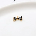 Macro detail of gold bow charm with black triangular zircon stones for jewelry making - Black Single Hanging Bowknot (LF2239)
