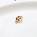 Macro shot of gold-plated copper flower pendant with four cubic zirconia stones - White Four Leaf Clover (LF2239)