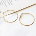 Macro shot of minimalist gold plated round hoop earrings with secure leverback closures - 35mm / K Gold