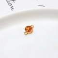 Macro shot of gold floral connector with orange zircons and dual loops for DIY jewelry - Orange Four Leaf Clover (LF2239)