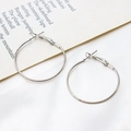 Detail view of silver-plated large hoop earrings on elegant silk fabric background - 35mm / White Gold