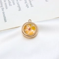 Detail of round gold plated pendant with real yellow dried flower and resin finish - 18mm / Yellow