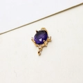 Macro view of purple oval zircon pendant with gold plated double loop connector - Deep purple