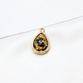 Macro detail of gold-plated waterdrop pendant with resin and gold foil flakes - Black Gold Foil Style