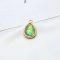 Macro detail of gold-plated waterdrop opal pendant with intricate wavy metallic edges - AB Aurora Light Gray