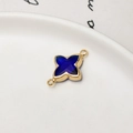 Close-up of blue glass four-pointed star pendant charm with gold-plated metal frame - Dark Blue