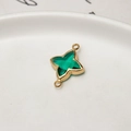 Macro shot of green faceted gemstone star connector with gold plated finish for DIY jewelry - Peacock Green