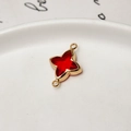 Detailed macro of a gold-plated four-point star pendant with a red gemstone for DIY jewelry - Red
