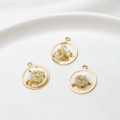 Detailed macro view of handmade resin flower charms with gold foil and white dry flower - Circle / White