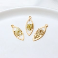 Macro shot of three marquise resin flower pendants with gold leaf and dried petals - Marquise / White