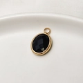 Oval birthstone pendant with faceted black stone and gold-plated copper frame - Black