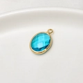 Oval light blue birthstone crystal pendant with a golden metal rim for DIY jewelry - Lake Blue