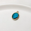 Oval dark blue faceted birthstone pendant with elegant gold-plated copper frame - Peacock Blue