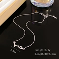 Macro shot of silver beaded chain with cubic zirconia arabic script pendant details - Silver