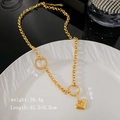 Collana con cuore in acciaio al titanio dorato con anello di strass e catena - Oro