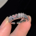 Detailed view of adjustable ring featuring pink heart and clear baguette-cut zircons - Step Cut Style (R332-58)