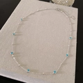 Collana in acciaio al titanio con perline blu malocchio e finitura argentata - Stile Perline Occhio Argento
