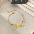 Close-up of gold chain bracelet with moon, bear pendants and red beads on display - Bear Moon Style (B338)