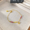 Detail of gold chain bracelet with red beads, LOVE plaque, and crystal heart charm - Love Heart Plate Red Bead Style (X2014)