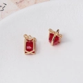 Macro shot of gold-plated red crystal gift box pendants for DIY jewelry design - Red