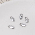 Macro shot of five silver 18K gold-plated lobster clasps on a white ceramic plate - 10 Style / Silver