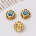 Macro view of gold flower beads with blue cat eye stone and micro-pave crystals - Flower Shape / Ancient Gold Blue Star Stone