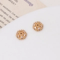 Macro shot of gold-plated snowflake flower spacer beads with micro-set zircon for DIY jewelry - Sunflower Style (03#7mm)