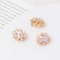 Macro shot of gold-plated windmill flower spacers with zircon for DIY pearl jewelry - White