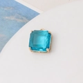 Macro view of light blue square gemstone pendant with gold claw setting for DIY jewelry - Lake Blue