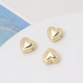 Macro detail of gold-plated heart beads with beaded edges for DIY jewelry making - 14K Gold