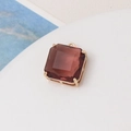 Close-up of a square cut reddish-brown gemstone pendant with a gold four-prong setting - Lotus Pink
