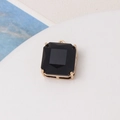Macro shot of a black square gemstone pendant with a gold four-claw setting for DIY jewelry - Black