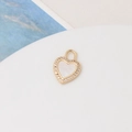 Macro detail of a heart-shaped gold-plated pendant with mother of pearl and tiny zircons - 27# Small Peach Heart (12*16mm)