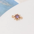Detail of gold plated sun charm with purple zircon and white crystal micro-pave - Violet